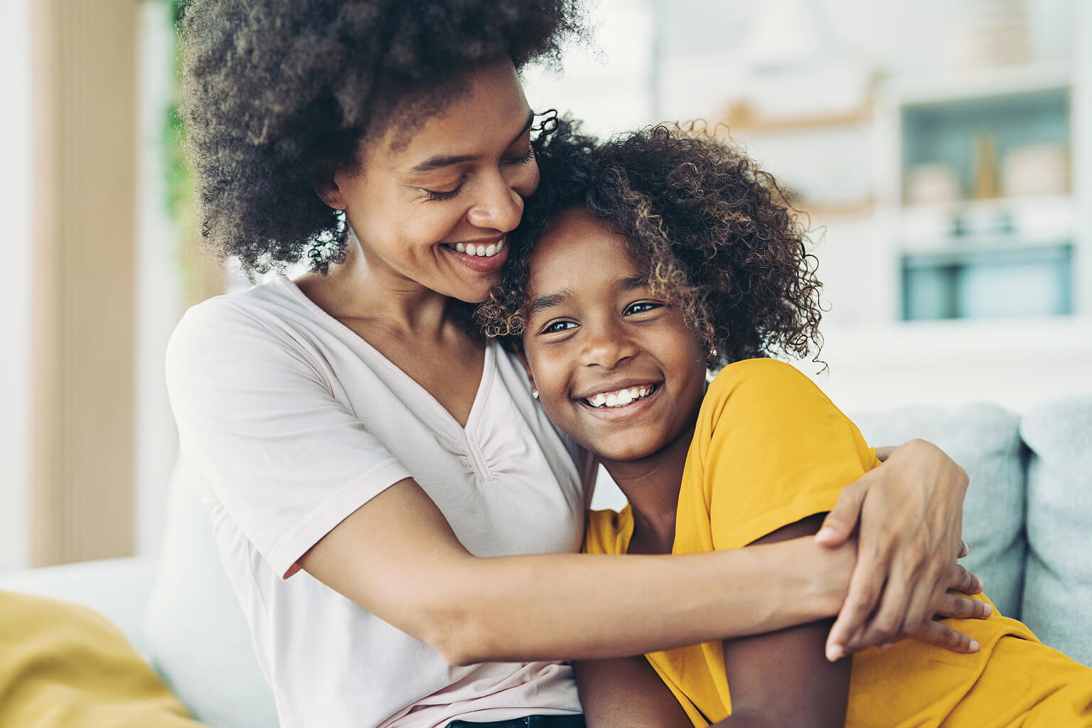 Woman hugging her daughter.