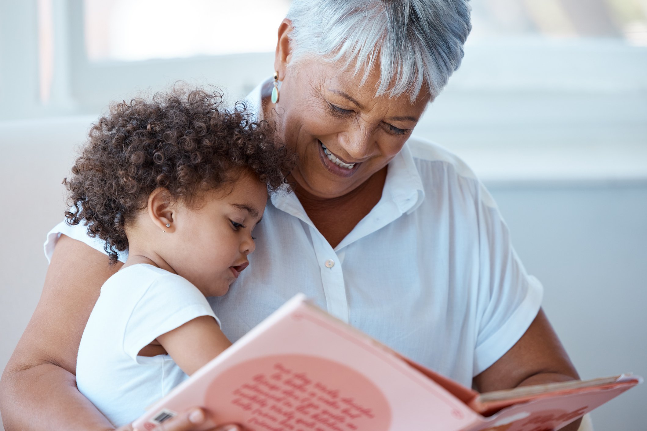 Grandmother reading child.