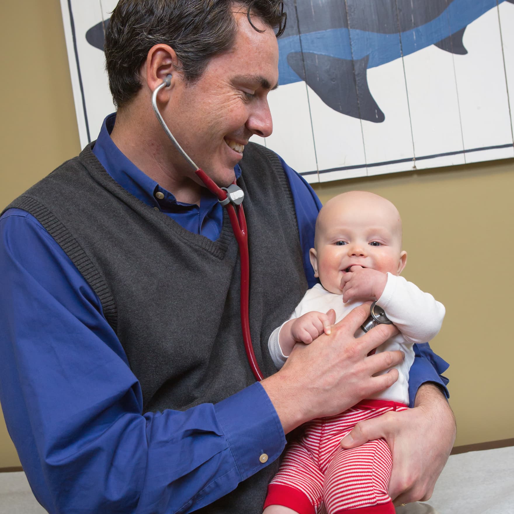 Doctor holding a baby.